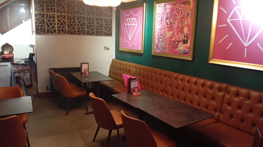 One of the seating areas complete with hanging artworks